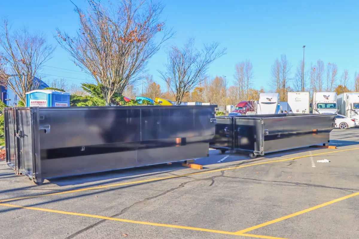 Professional dumpster rental service with roll-off container on residential driveway in Virginia Beach